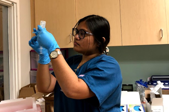 Kristine Abadilla prepares an injection.