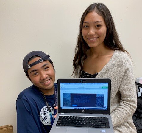 Pictured: Jerrick Josue and Kuualoha Andrade display a prototype of the website they designed to support the Office of the Public Defender. 