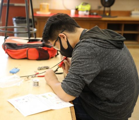 With the new hybrid schedule, students like senior Chansen Tano (above) resume hands-on  activities on campus after three quarters of virtual learning. 