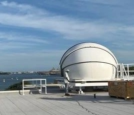 The telescope sits on the roof of C-building, overlooking Pearl Harbor.