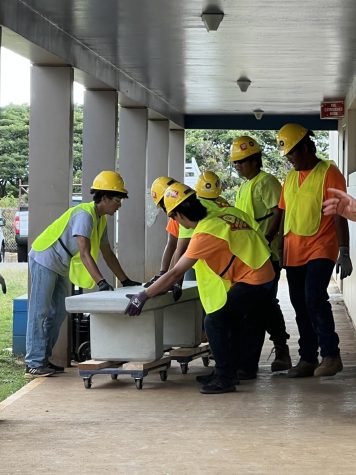 BreakingGround 808 participants transport precast concrete benches to place on campus. 